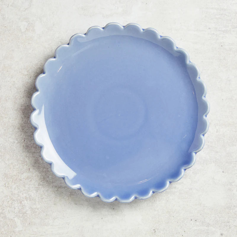Light blue scalloped plastic dinner plate